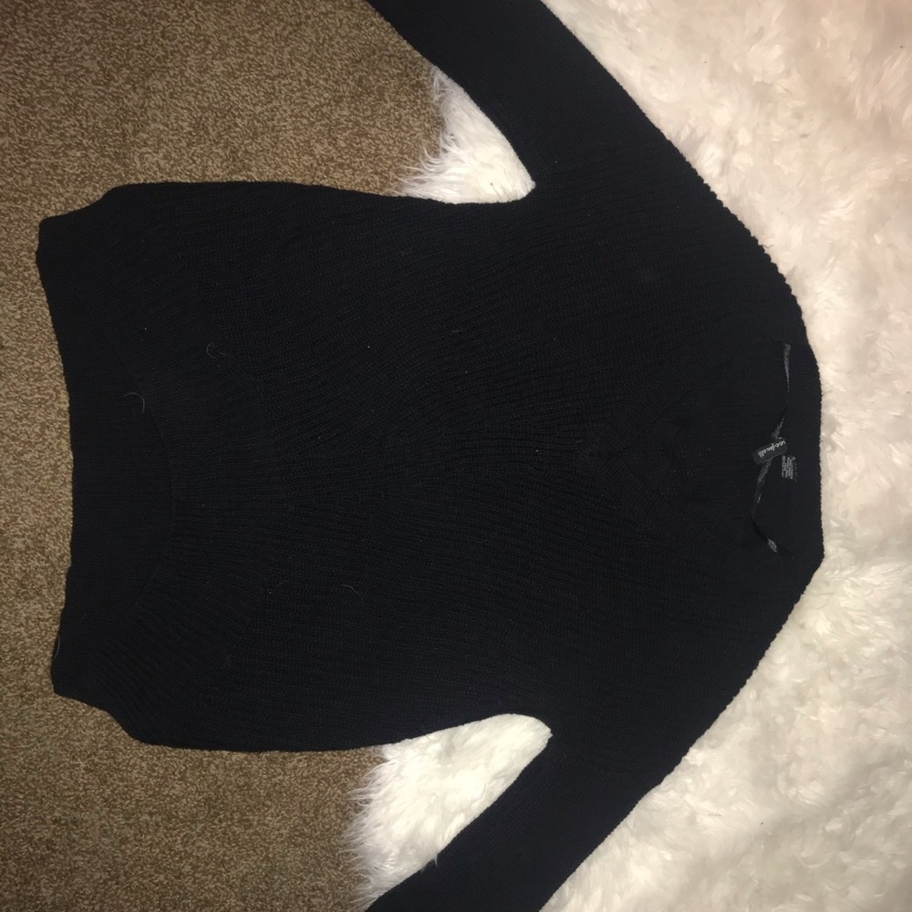 Black sweater with crisscross detail on chest